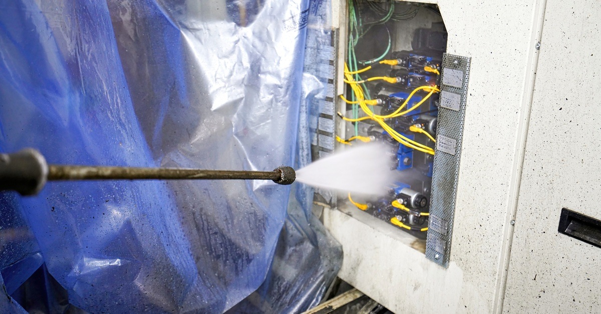 A large spray-cleaning machine that power-washes contaminated components and assemblies with washing liquid.