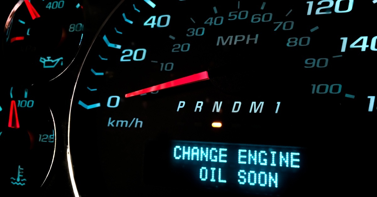 The needle of a vehicle's speedometer points at zero. The phrase "Change Engine Oil Soon" is below the needle.